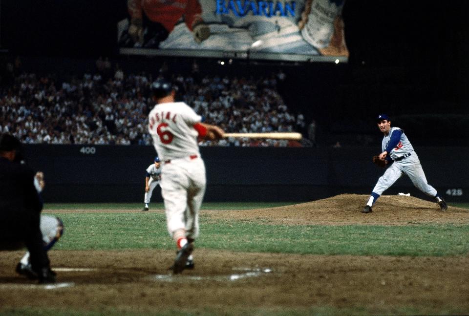 Stan Musial getting a hit off Sandy Koufax, 9/17/1963. Photo by Neil Leifer #MLB #HOF #Cardinals #Dodgers