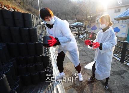 bomi participating on a charity briquettes event along with block b jaehyo