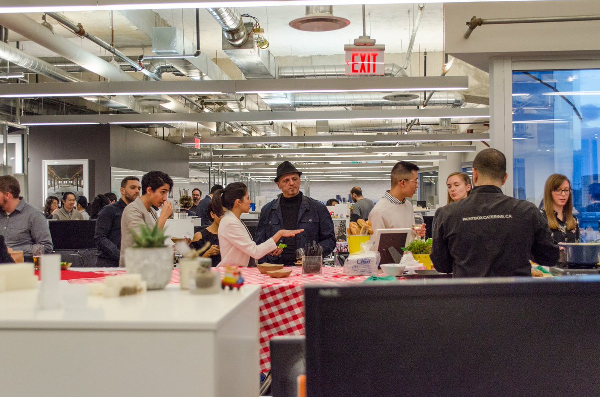 staff mingling at a catered event in the Quadrangle Studio