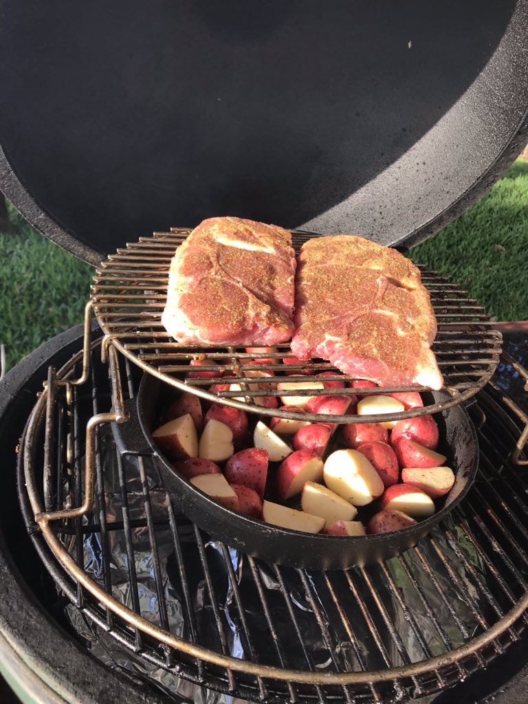 DrBBQ's tweet photo. Dinner is rolling! #Pork steaks dripping some tasty pork fat into red potatoes in the #Bge small skillet. All stacked up on the #eggspander #bgeteamgreen @BigGreenEgg https://t.co/RpQ9yK1Ojc
