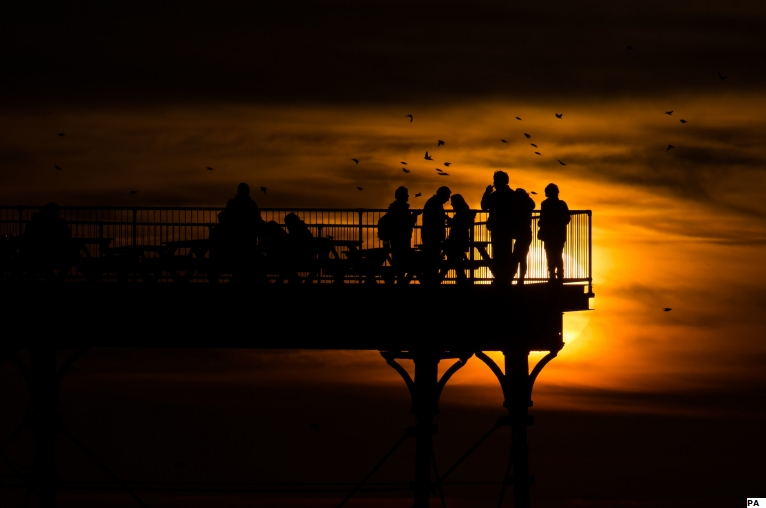 bbcweather's tweet photo. People enjoying the warm weather from the Royal Pier on Aberystwyth beach in Wales yesterday. https://t.co/p6A2jezN5M