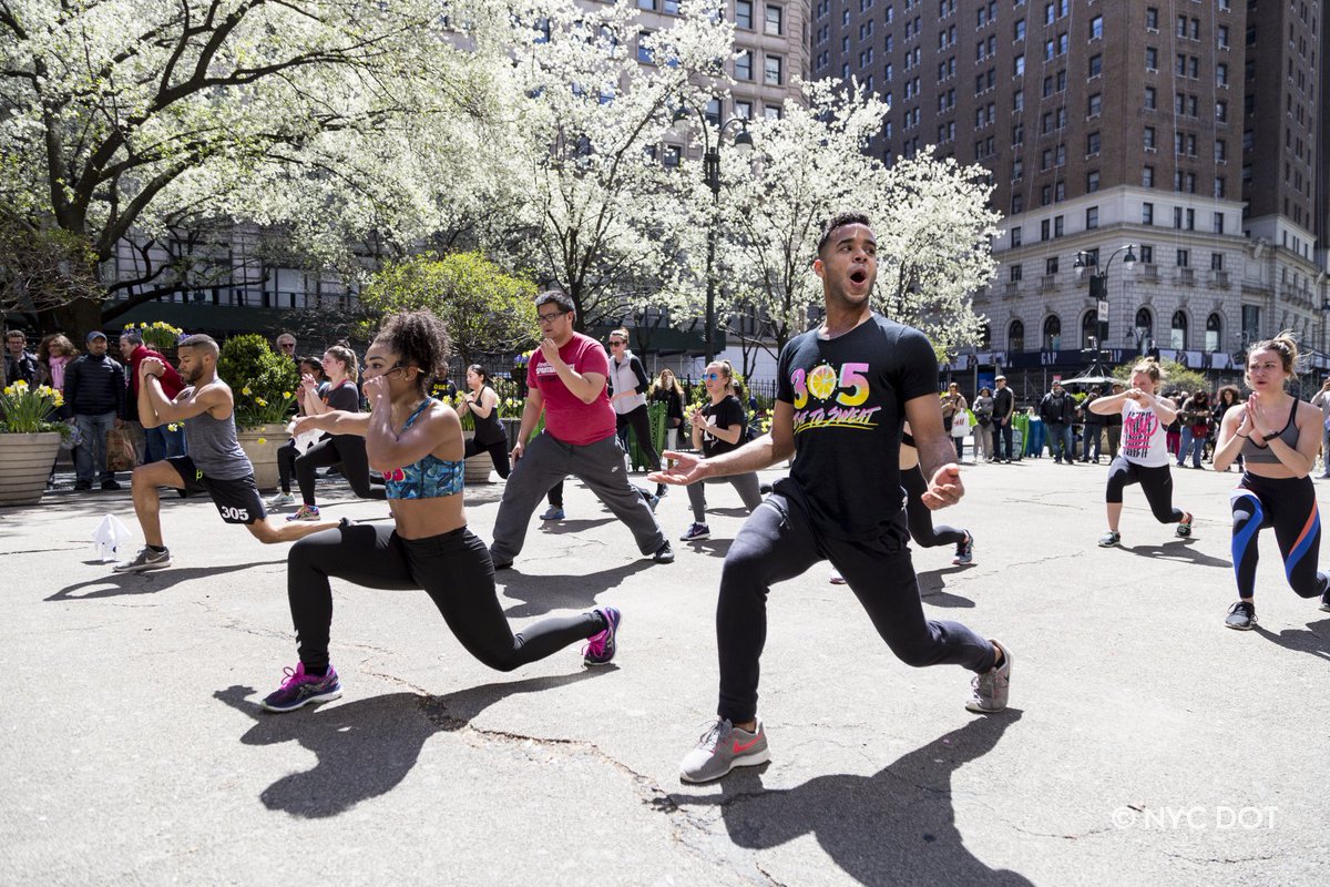 A fitness class being held in a car-free street in celebration of Car-free Earth Day