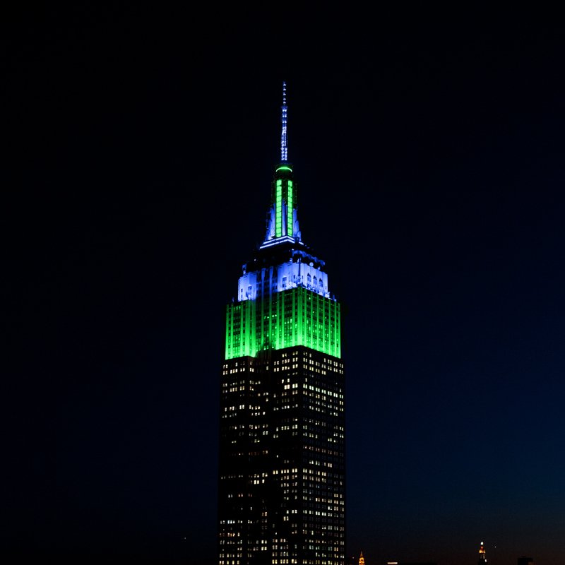 EmpireStateBldg's tweet photo. We're shining a light on National Eating Disorders Association Awareness Week by glowing in green &amp; blue tonight in honor of @NEDAStaff. https://t.co/RlylDLo7LR