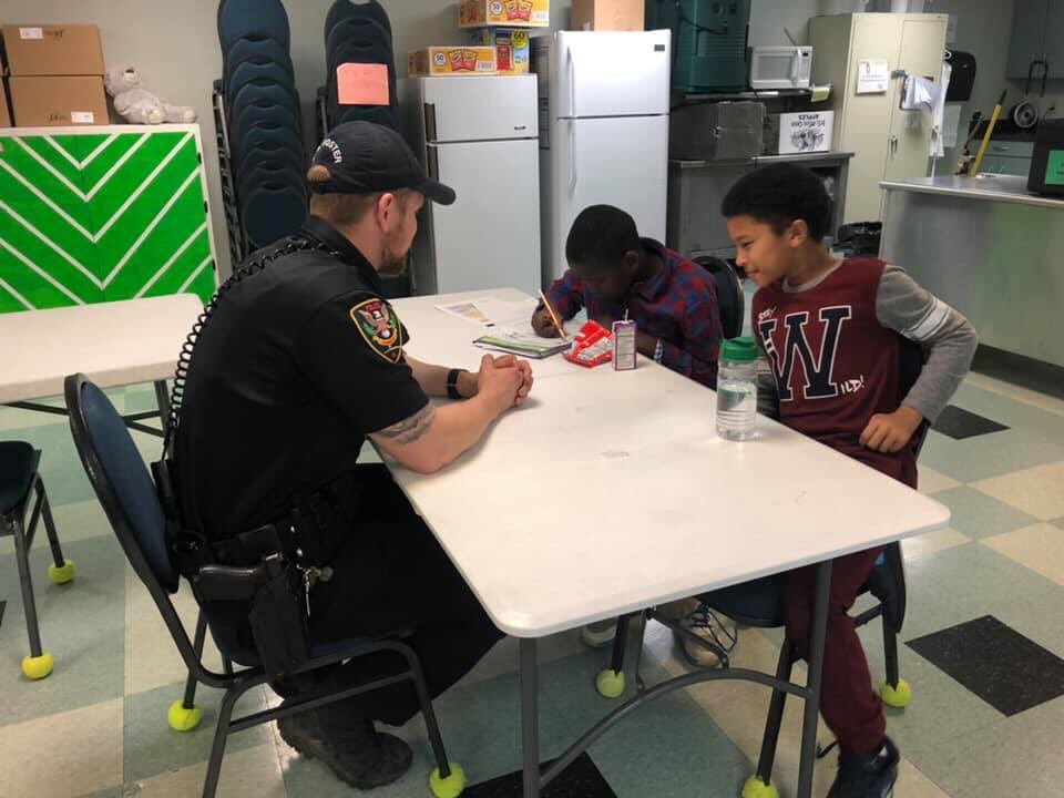 roanokepolice's tweet photo. Officer S. Foster is nailing these fractions! Having a lot of fun at today’s #RPDHomeworkHelpers at St. John’s Episcopal Church’s Community Youth Program! https://t.co/meiiQcgQ4X