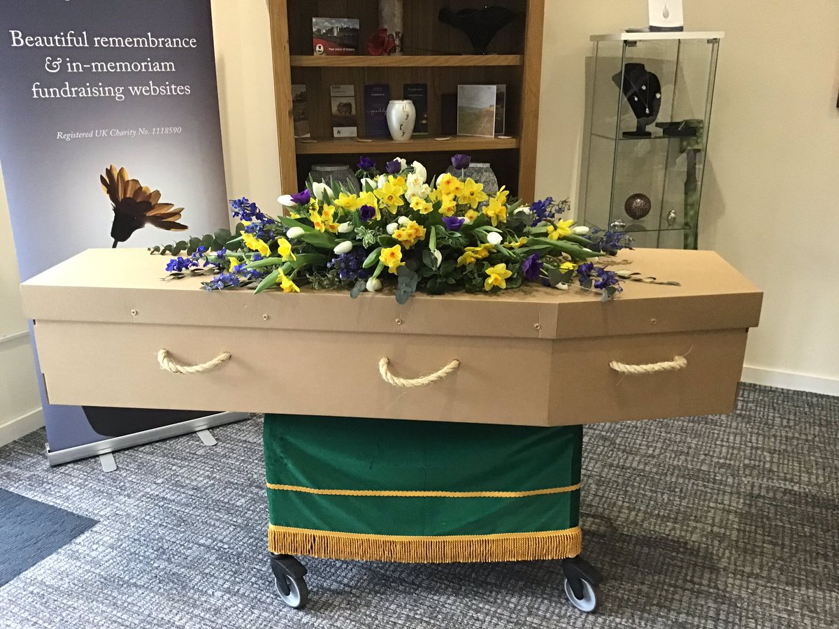 Simple plain brown cardboard coffin with amazing flowers by Rosie Orr. The completely transformed the look of the coffin.