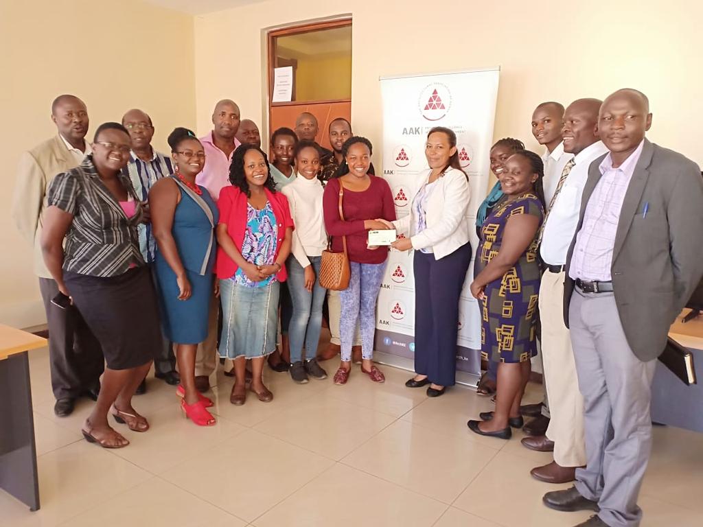 Arch_KE's tweet photo. AAK President, @EmmaMiloyo issuing a cheque to AAK Bursary beneficiaries. The AAK Bursary initiative is supported by the AAK BuildRun that takes place every year in July https://t.co/U0abRBUMIq