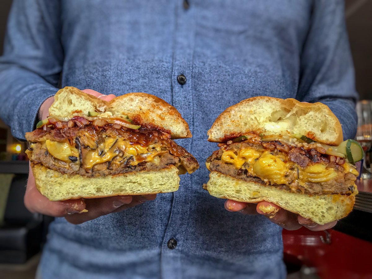 VeggieGalaxy's tweet photo. New Blue Plate starts tonight:
BBQ Bacon Mac & Cheese STUFFED Burger (inspired by @tFimB & veganized)!
House-made beef-style burger stuffed w/shiitake bacon mac & cheese, on a grilled bun and topped w/pickles, grilled red onions & BBQ sauce. Side of fries. #vegan (Dinner only) https://t.co/eHhYwXy9oe