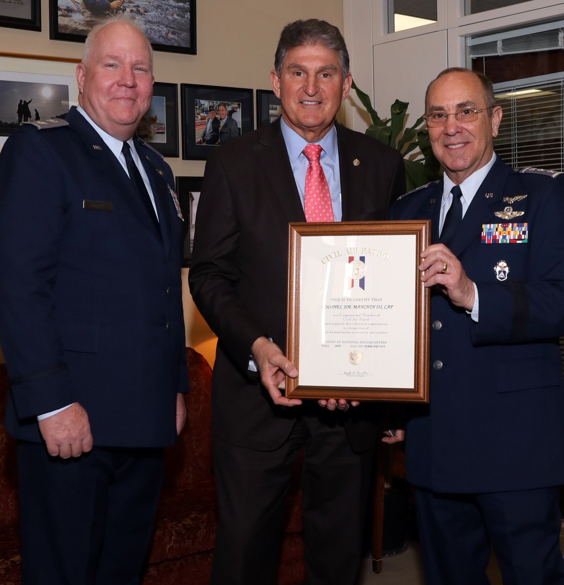 U.S. Sen. Joe Manchin, D-W.Va., holds the CAP membership certificate he received from Col. James A. Dodrill (left), West Virginia Wing commander, and Maj. Gen. Mark Smith, CAP national commander and CEO, reflecting the legislator’s new CAP rank of colonel as vice commander of the Congressional Squadron. Photo by Susan Schneider, CAP National Headquarters