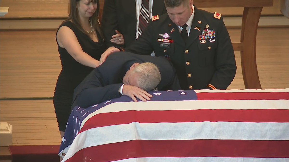 Officer's Galinger's father cries over his son's casket