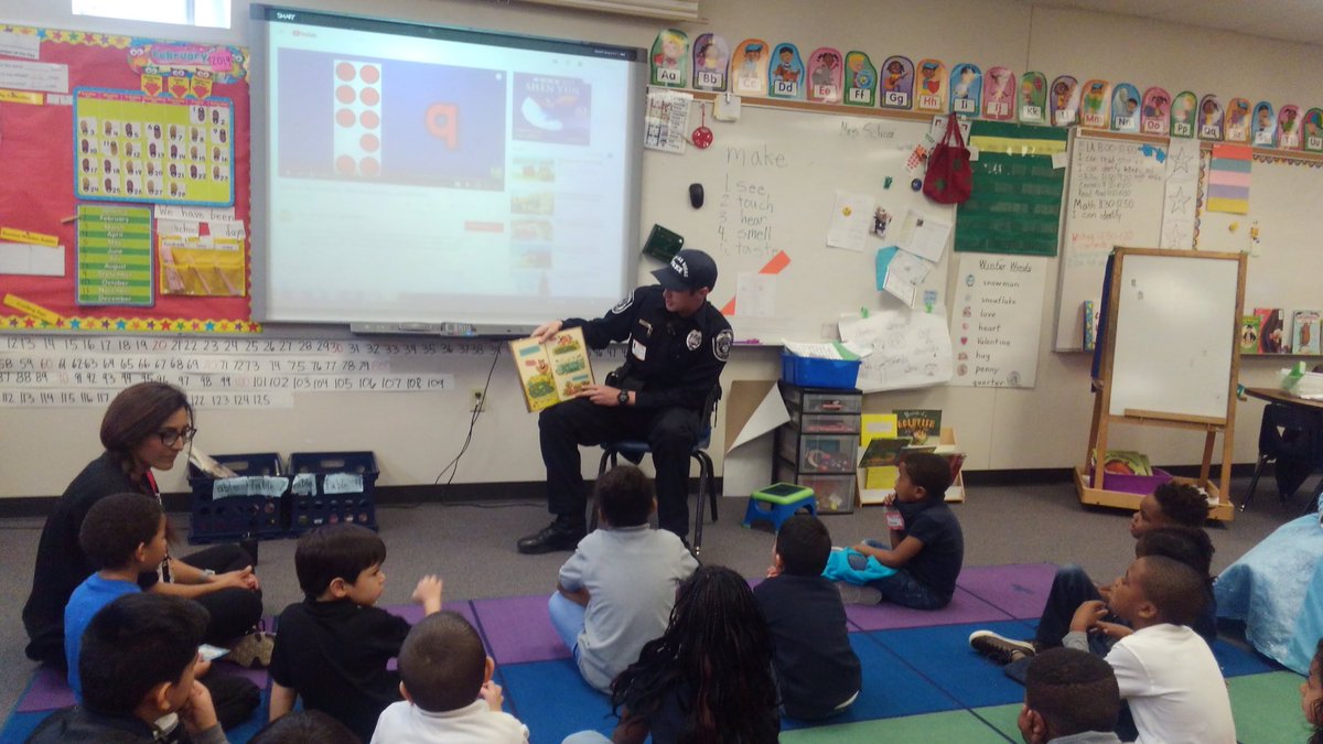 NLVPD's tweet photo. NLVPD Officer Walker was out at Jesse Scott Elementary this morning ready to some young students. I think he found some friends. #nevadareadingweek2019 @CNLV https://t.co/JO5oFvoCjj