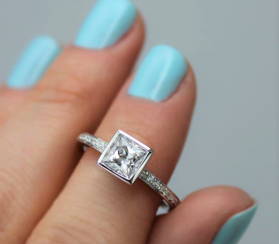 A perfect princess cut diamond engagement ring by Canadian designer Noam Carver.  Stop by Touch of Gold to try an oval, pear shape, cushion cut or rectangular diamond ring.....you may be surprised which will be your favorite.