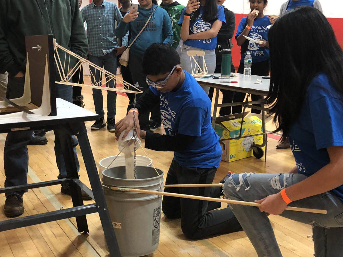 Navya steadies the bucket as Arav pours the sand. “Bob” the Boomilever held more than twice its weight. @HPS_Eagles #ScienceOlympiads