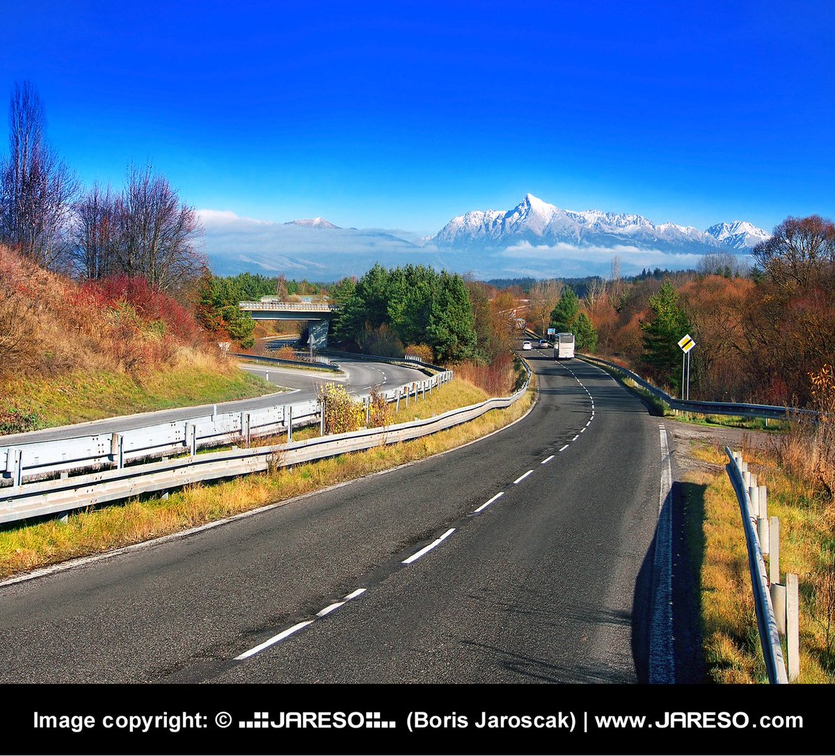 jareso's tweet photo. A #colorful #travelphotography of #road leading to a snow-covered #Krivan peak that dominates the upper part of #Liptov region, #Slovakia. This #Slovak #mountain is a part of #HighTatras; a range of the #TatraMountains chain, popular #travel destination in the heart of #Europe. https://t.co/PijOBNz0XO
