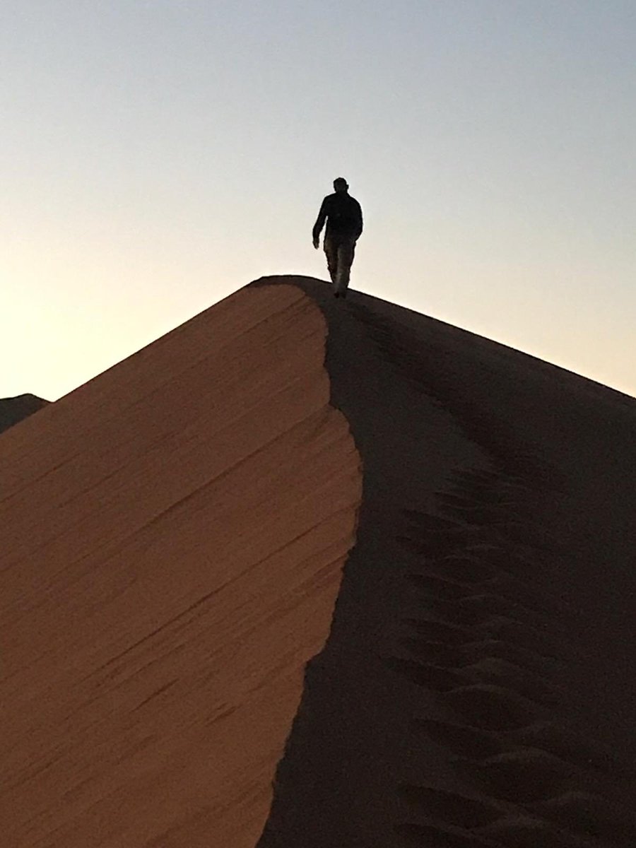 My husband and I climbing the Sossusvlei Dunes in Namibia Africa