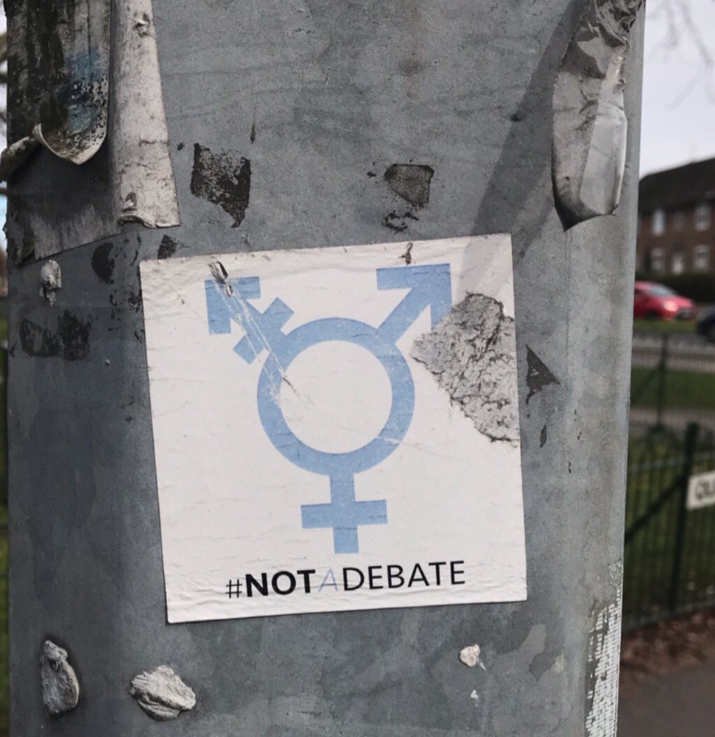 Trans lives are #NotADebate. Amazing to see my sticker design still standing, and still relevant, a few years after the protest.