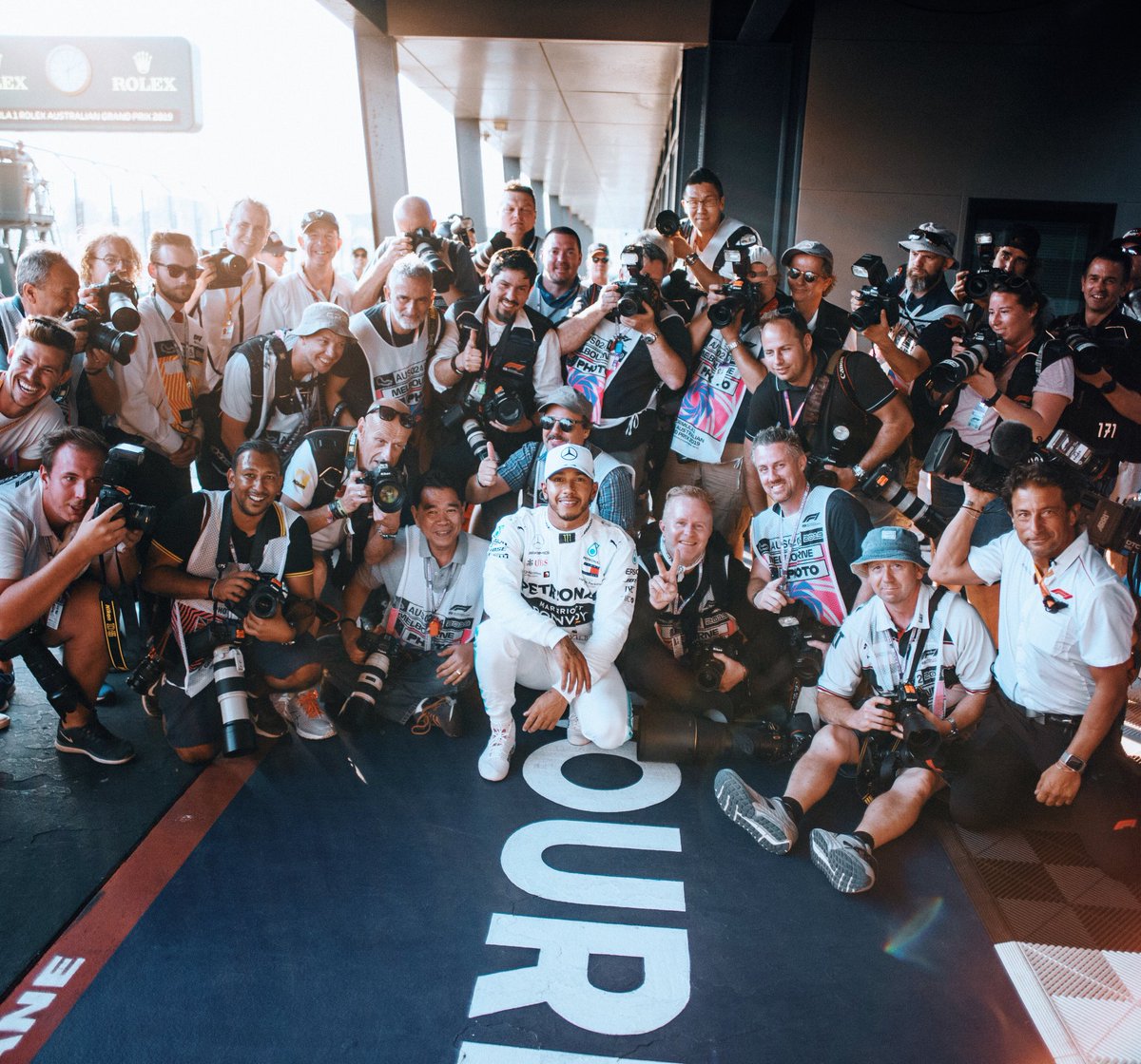LewisHamilton's tweet photo. I took this picture after qualifying with all the photographers that have photoed me for the last 12 years. I wanted to take this moment with them as life is precious and can sometimes fly by. I know I’m not always easy to work with photo wise but I do appreciate you, thank you https://t.co/wjgAait9R0