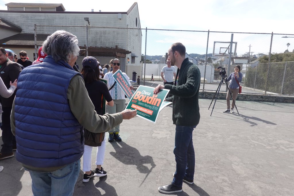 Chesa Boudin handing out window signs in Bernal Heights