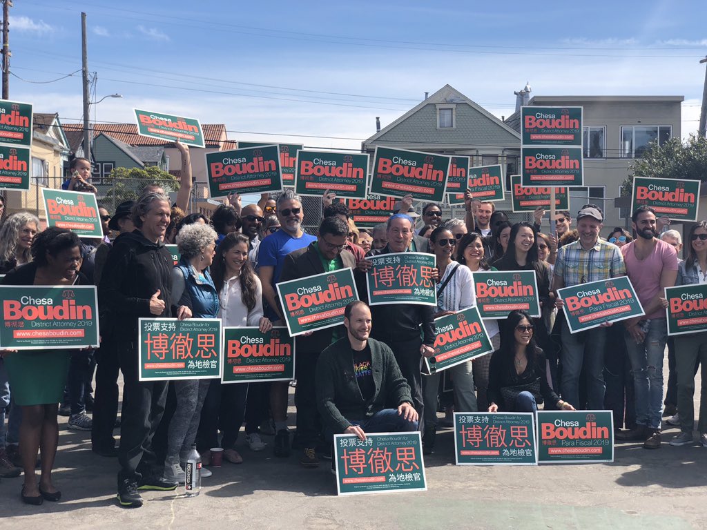 Part of a larger group gathered to drop lit for Chesa Boudin in Bernal Heights