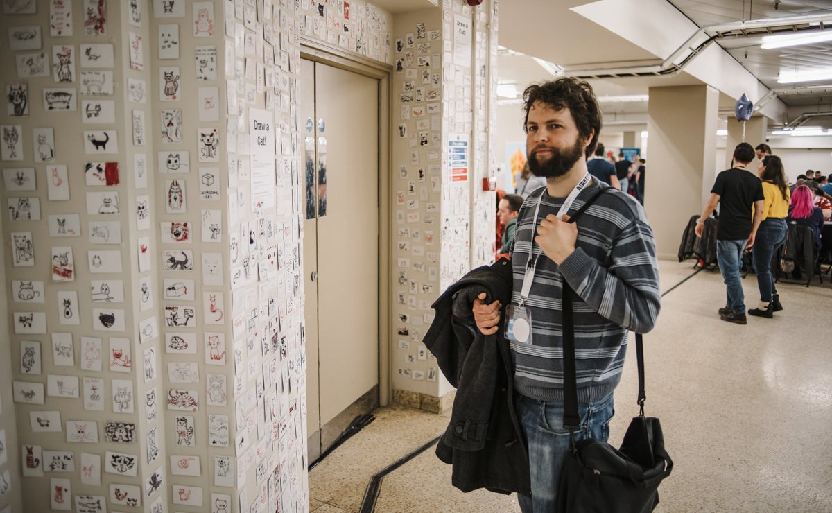 WiseFrogGames's tweet photo. More photos from our trip to @aireconuk - (3/6)

@platocaves peruses the legendary wall of cats from @stuffByBez (our own Two-Face inspired co-contribution turned out slightly unsettling) before we sit down to try out the manic Kitty Cataclysm which Bez was trialling at the show. https://t.co/UMvlq3NrNC