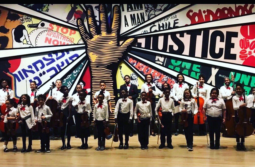 ATLmusicproject's tweet photo. Quick pose in front of the Paula Scher mural at National Center for Civil and Human Rights just before performing for Bank Of America's Neighborhood Builders Emerging Leader Program. #standingovation #empowered #young #musicians #human #hand #atlanta #neighborhood #dillavenue https://t.co/MJDUN6muRm