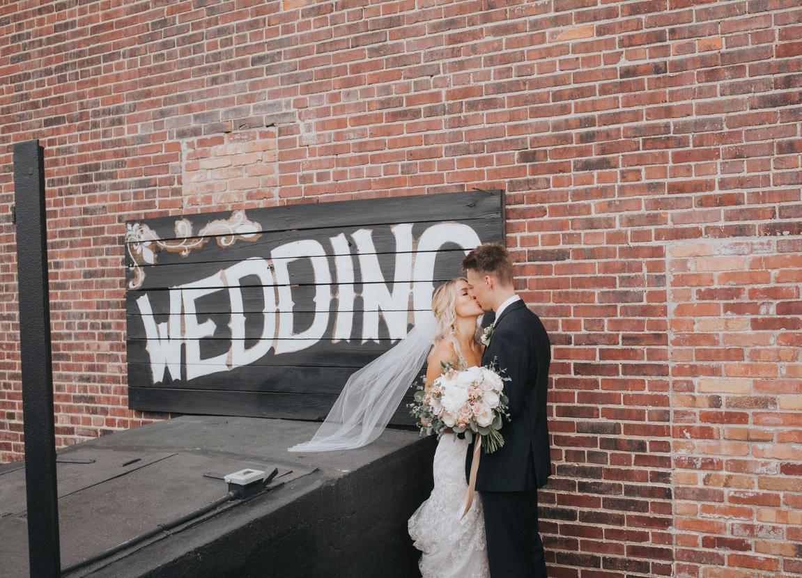 Couples love getting their picture with our wedding sign! 
📷: Kate Kerr