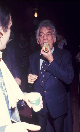 Leonard Bernstein taking down a hot dog.