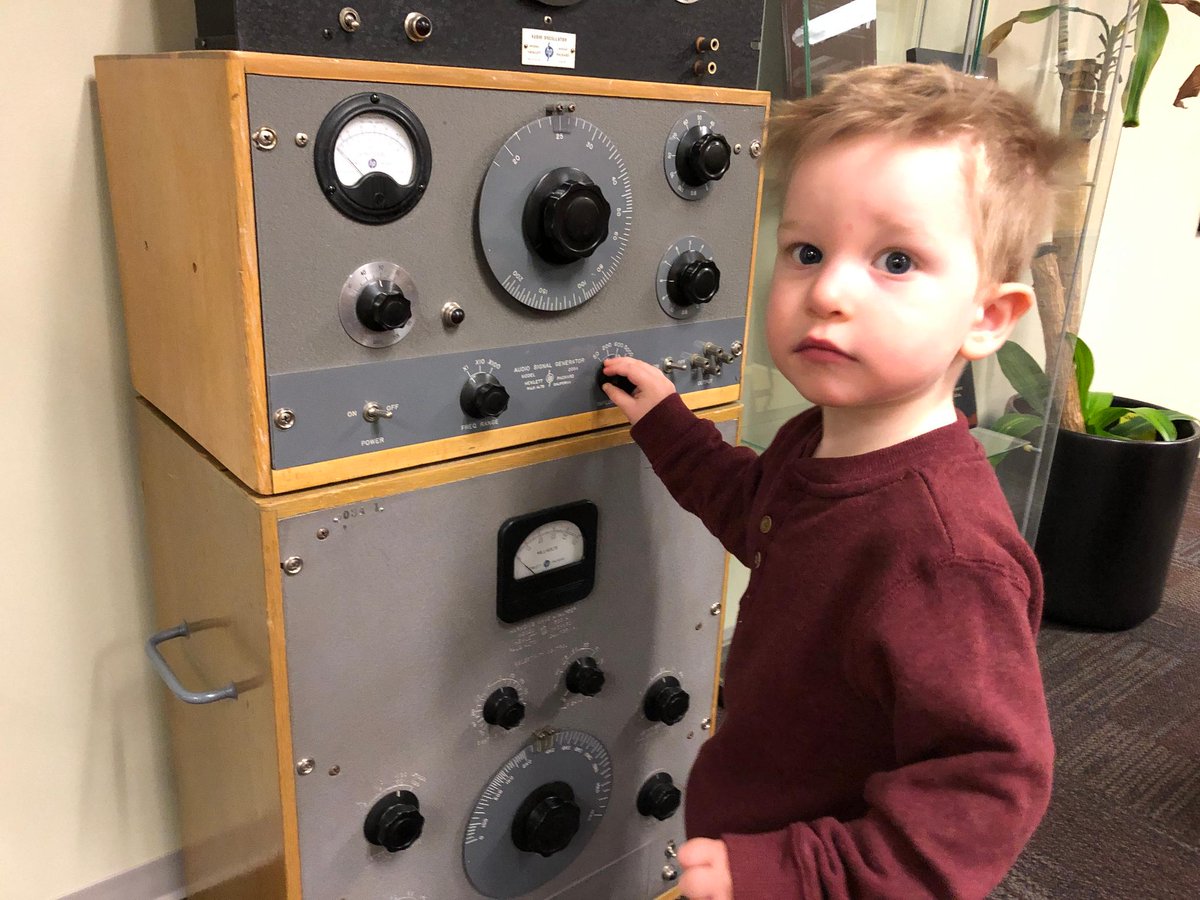 Keysightcareers's tweet photo. Every year Keysight Everett site hosts a fun Holiday Brunch with our families. This year, Jim’s two-year old grandson, Colby, attended the event. Here, Colby is learning about one of our earliest products, the HP 200CD Audio Oscillator. Way to go, Colby! #ThisIsKeysight https://t.co/I8HQ6yhakC