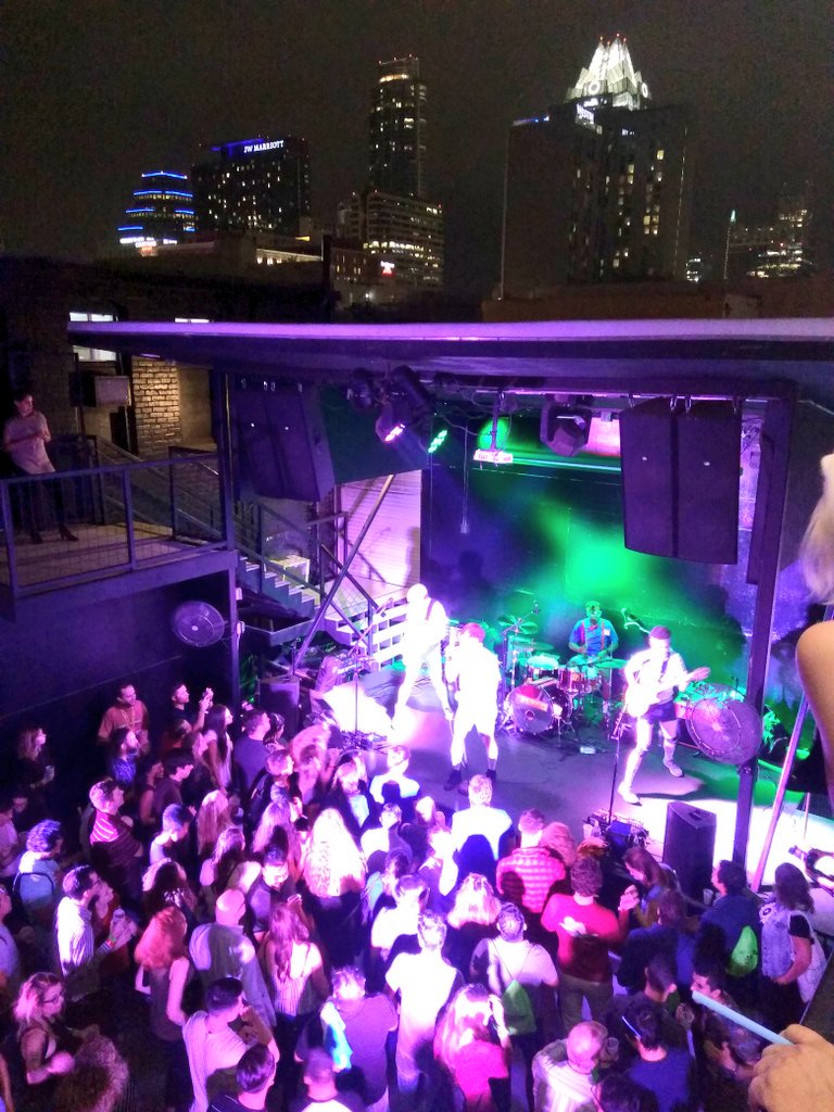 ATxMu's tweet photo. .@TheSpazmaticsTX play us out @ATXStartupCrawl! #SXSW #SXSW2019 #SXSW19. #ATxStartupCrawl, view from VIP @CapitalFactory, #FrostTower in bg. https://t.co/nlpO1zQ9ub