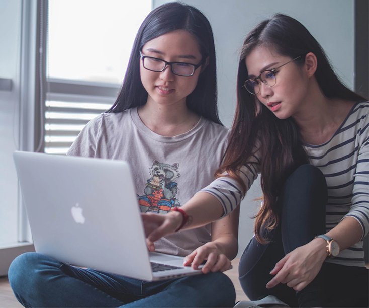 women in discussion over a laptop