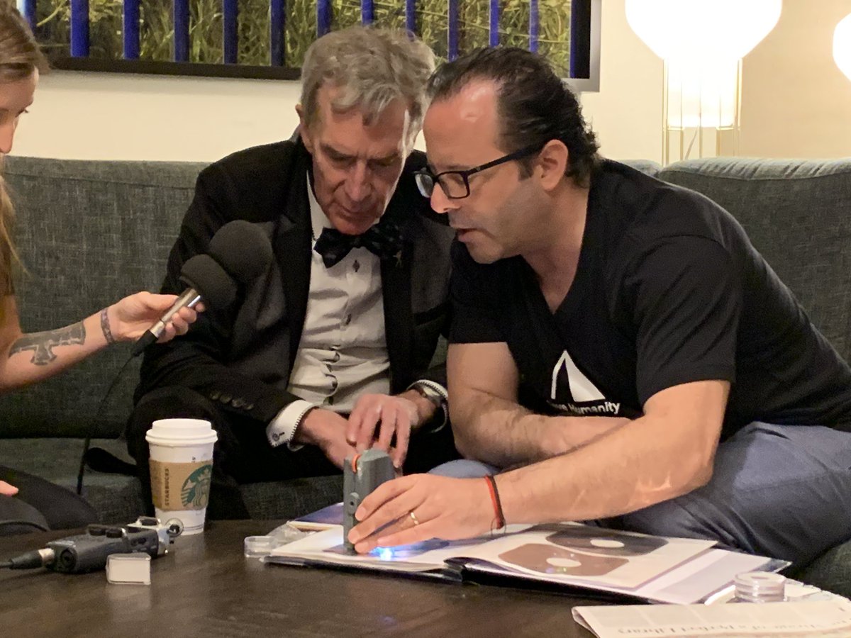 MattHoerl's tweet photo. Bill Nye and Nova Spivack examine a copy of the Lunar Library at SXSW! #SXSW2019 #archmission #SpaceSaturday #Space #SpaceIL https://t.co/ydEcFOh8EU
