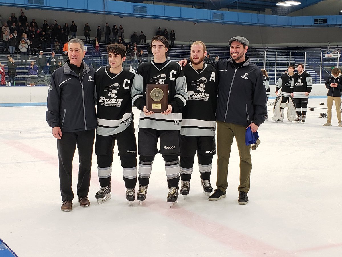 Pilgrim senior captains Matthew Pacheco, Jack Clements and Ryan Pietros accept the RIIL Division III Boys Hockey plaque w/ Patriots head coach Michael Boyajian Jr., far right, and assistant coach Michael Boyajian Sr., far left