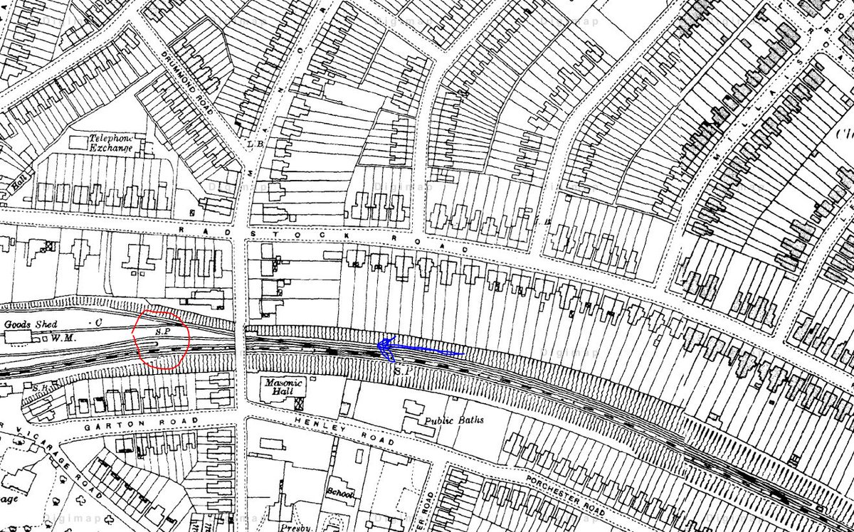 A bit more searching on period maps shows the likely railway cutting and bridge to be Woolston. The photo was taken from the blue arrow - notice the station platform and curved track (in red) behind the bridge. The streets to the north are probably those visible in the video.