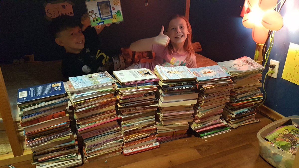 The book tower made from C's books from her bookshelf. Note - She has read every one and many more!