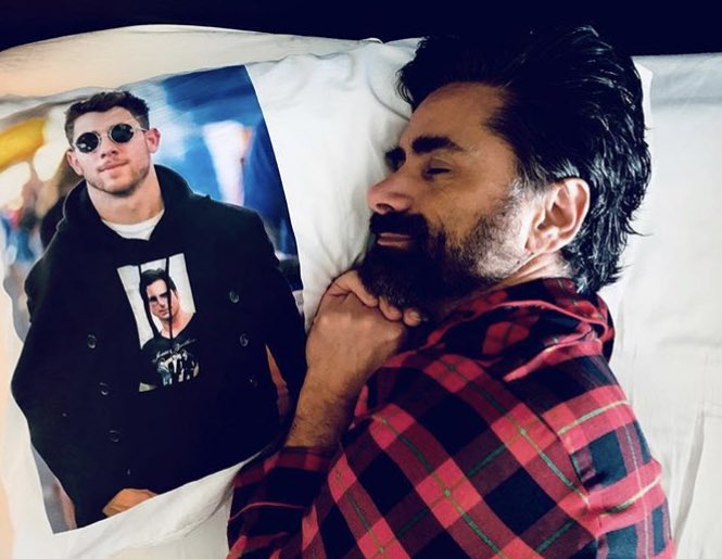 archivesjonasb's tweet photo. nick jonas lying with a picture of john stamos lying with a photo of nick jonas with a shirt of a photo with john stamos with a jonas brothers shirt.

this is the tweet https://t.co/g9qMiQrjuM