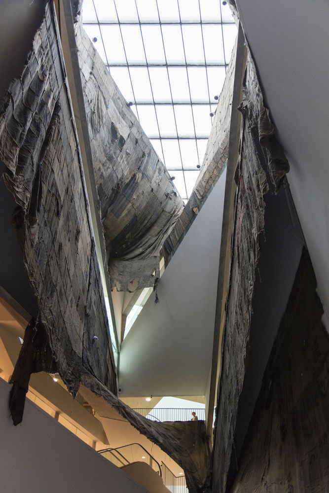 NorvalFdn's tweet photo. The humility of the hessian sacks used in "Ibrahim Mahama: Labour of Many" is contrasted with the spaces its installed in. From Ghana, to Venice, and now in Norval Foundation until August 11th. 

#IbrahimMahama #Installaion #VeniceBiennale #NorvalFoundation https://t.co/O2G7vnwGPm