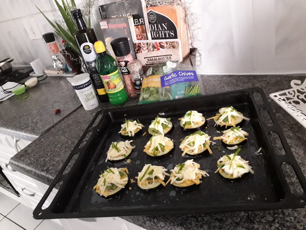 Eggplant Cremes.
Eggplant sliced
Topped with a dash of Lemon juice
Salt and pepper
Cheddar cheese
Sour cream
Coriander leaves
Mozzarella 
Garlic chives
Olive oil and Baked till sizzled
Everything kinda drools from the sides, but who cares...they are waaay less carbs