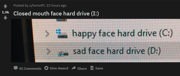 It's a post from Reddit, showing a screenshot of someone's harddrives on Windows. They've renamed C: drive to be "happy face hard drive" and D: drive to be "sad dace hard drive". The title of the Reddit post is "Closed mouth face hard drive (I:)"