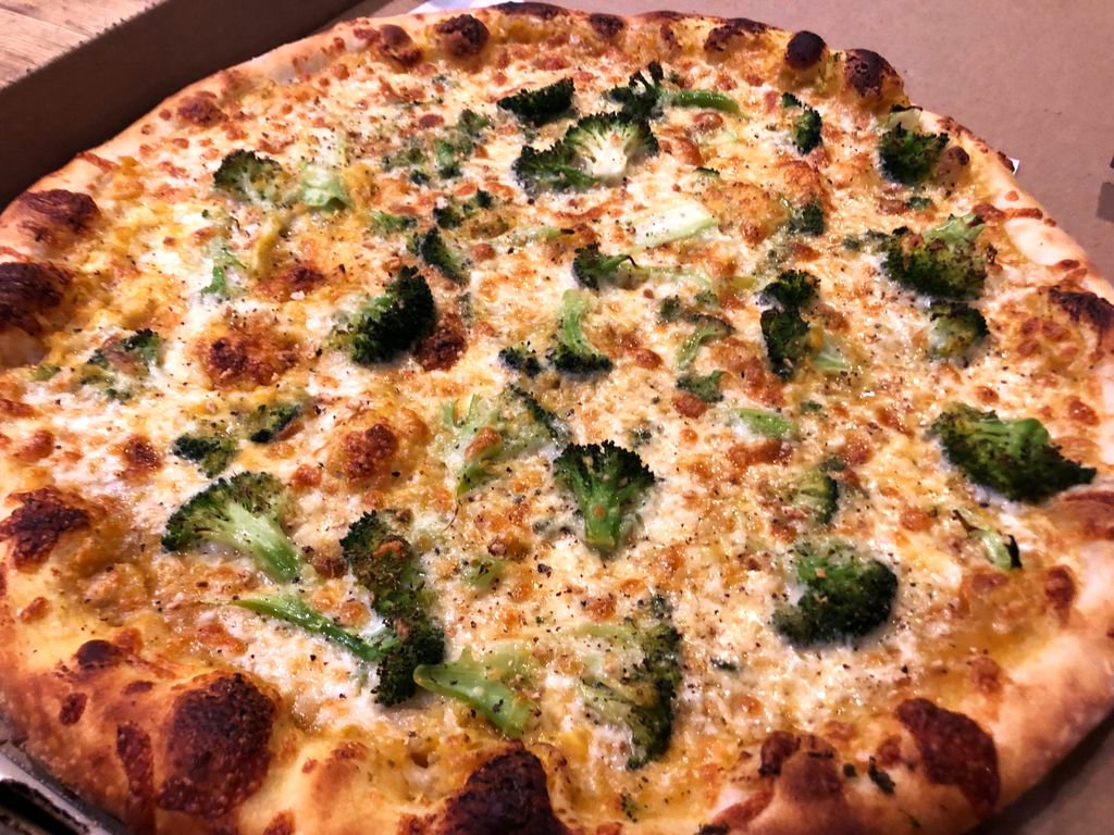 Marinated broccoli &amp; white cheddar w/ hazelnuts. Butternut squash purée in lieu of tomato sauce. The world's first chaotic good pizza