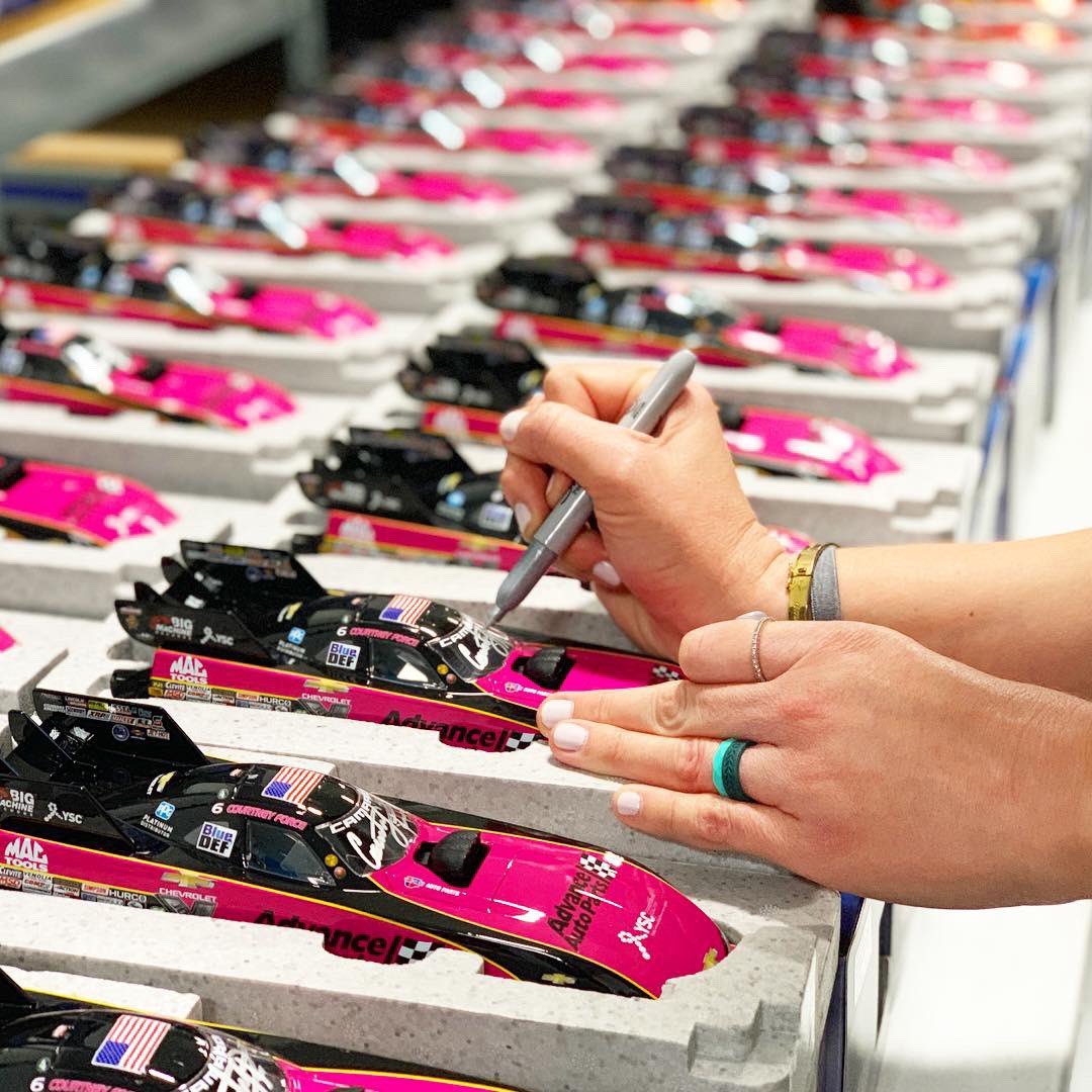 courtneyforce's tweet photo. Lots of @AdvanceAuto die cast funny cars to sign at the shop today! Love this pink @YSCBuzz car that I ran for #breastcancerawareness month. One of my favs. 💕 
.
.
#Autographs #Diecast #OneDownLotsToGo #AdvanceXForce #YSC #JFR #QALOteam https://t.co/u0RIelij7E
