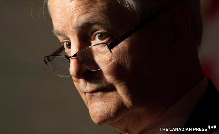 Minister of Transport Marc Garneau listens to a question following a news conference in Ottawa, Wednesday October 31, 2018. THE CANADIAN PRESS/Adrian Wyld