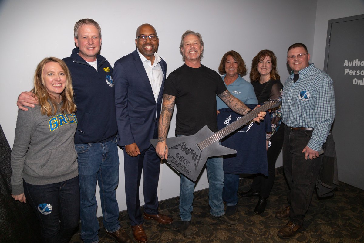 AWMHFoundation's tweet photo. Thanks to President Bill Pink and Executive Director of Workforce Training Julie Parks for presenting James with this awesome, heavy guitar! #MetallicaGivesBack #AWMH #MetInGrandRapids https://t.co/wtpl9N9mBv