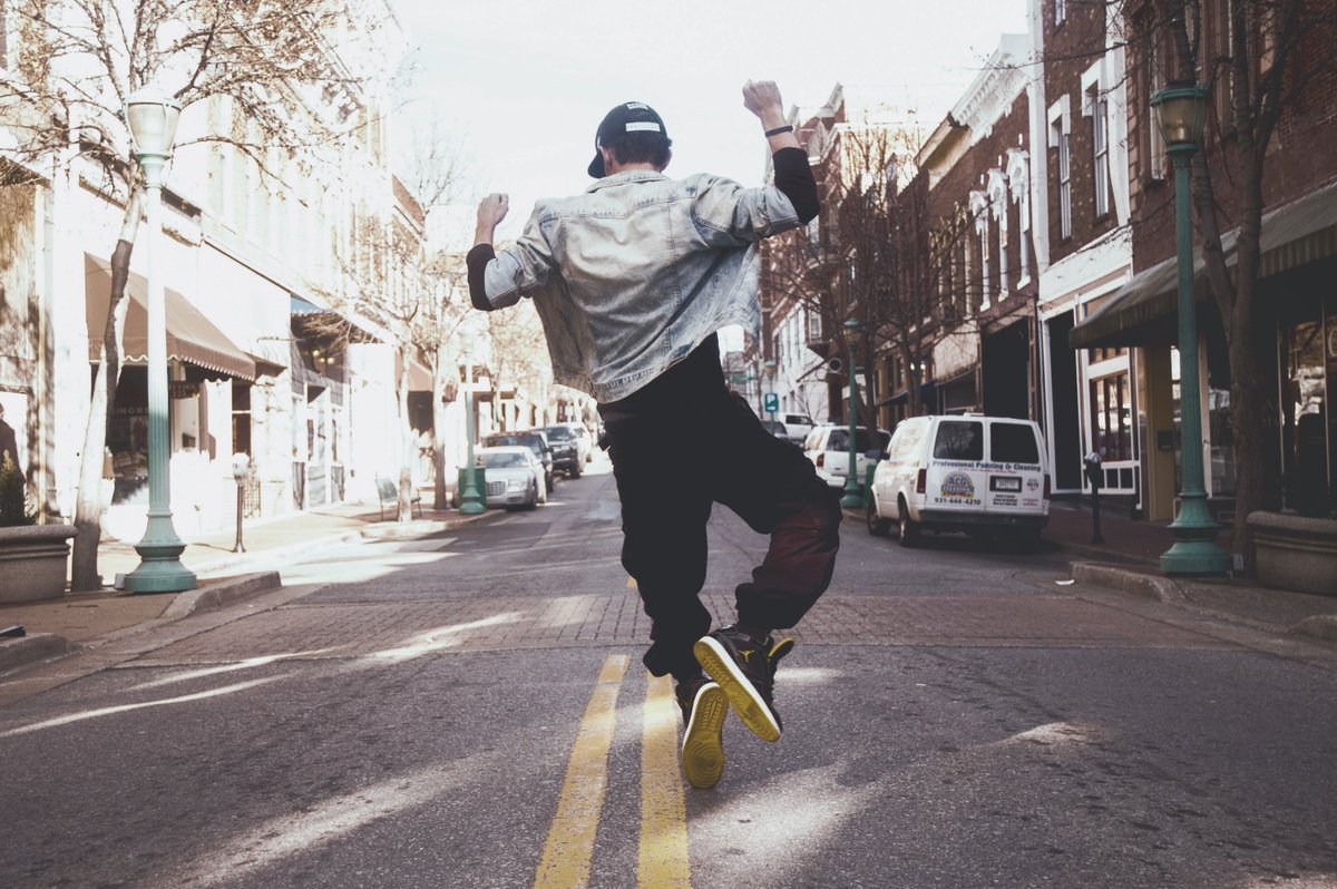 Imagine why this guy is dancing in the street.  What say you?