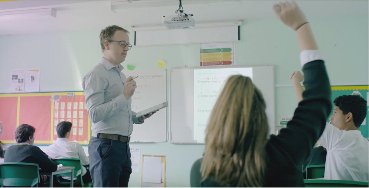 Teacher delivering a class to his students.