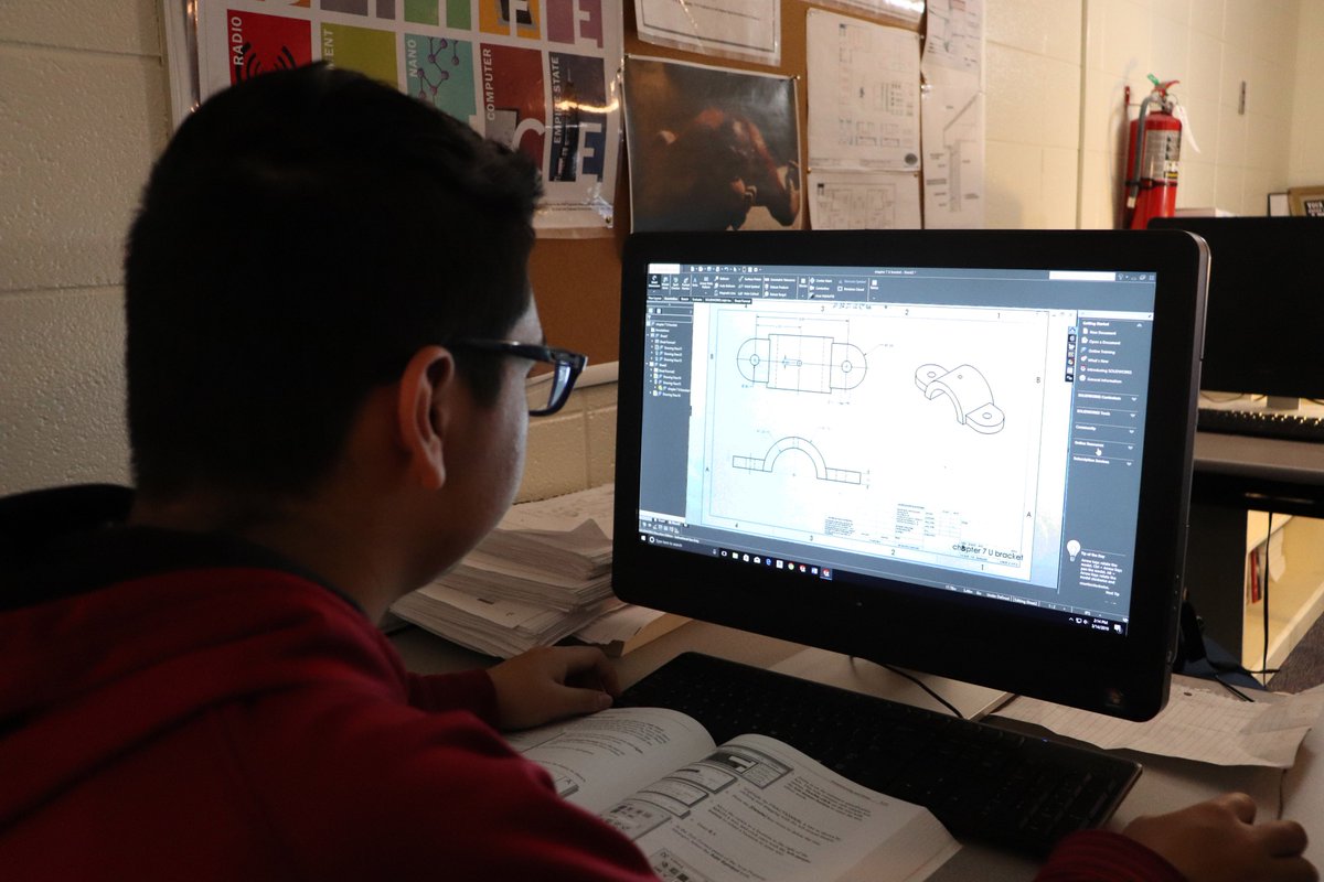 dmtcsc's tweet photo. Engineering Graphics II student Juan Paniagua formats a drawing setup from the U-bracket part he created in Solidworks.  #DMTC50Strong #DMTCEngineeringGraphics #MsEdgins https://t.co/ygvzQKjxUc