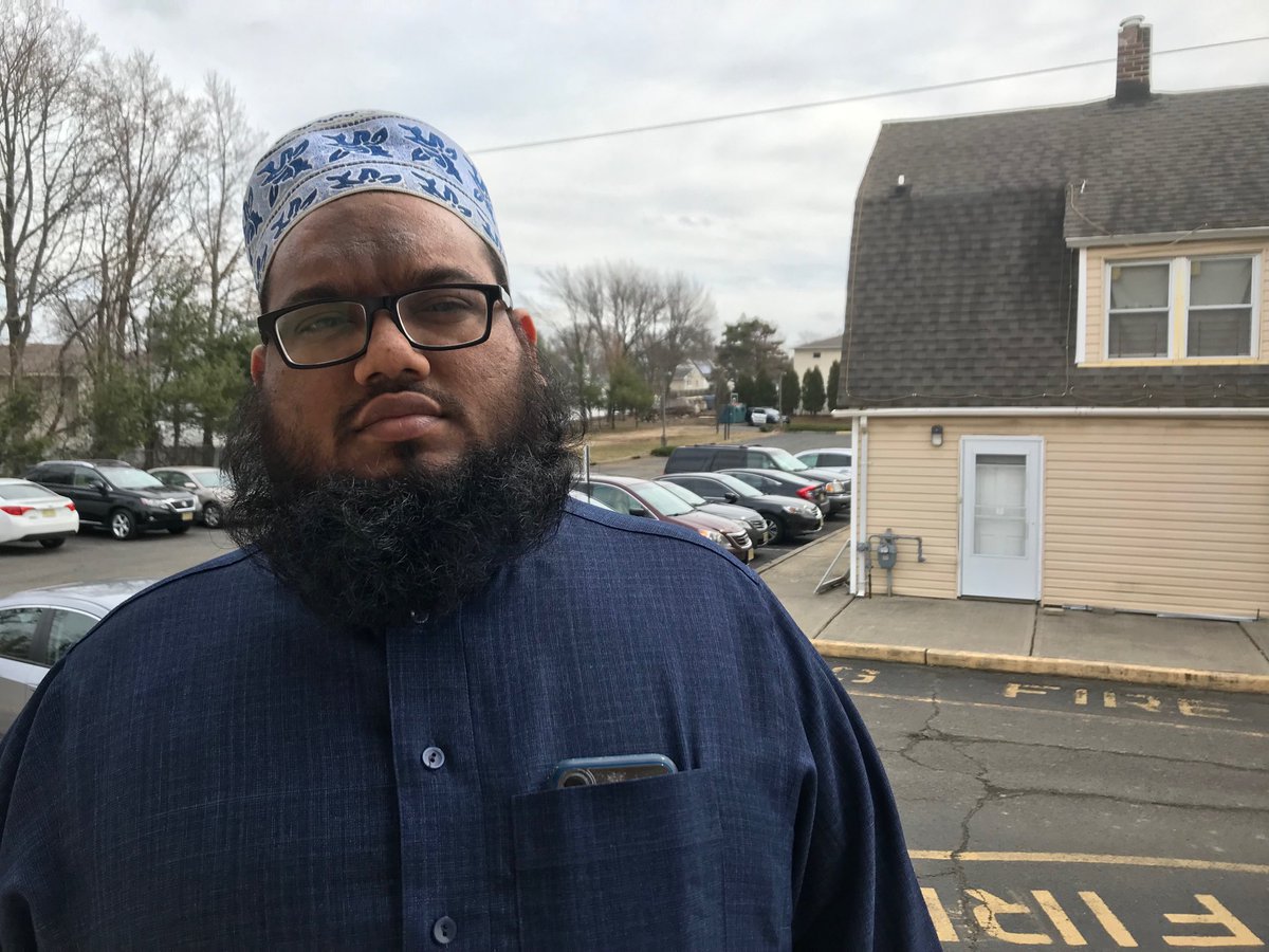 Imam Khalid Raza of the Islamic Center of Old Bridge as he prepares for Jumua, a Friday prayer service, with a police cruiser in the background. Raza says the apparent live-streaming of the New Zealand mosque  attack raises the level of horror.