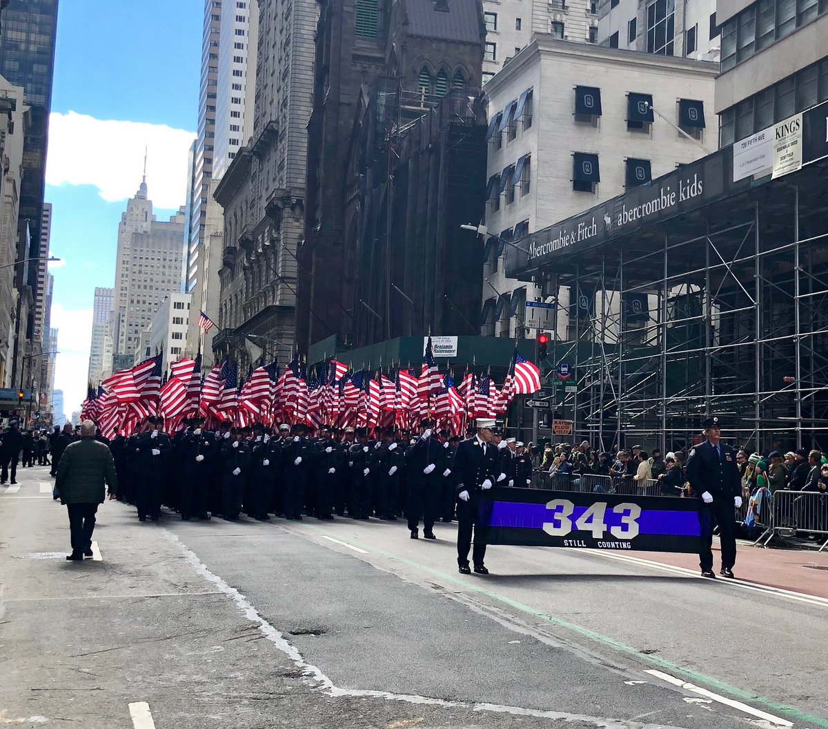 FDNY's tweet image. #FDNY members have been carrying the 343 banner and flags in #NYCStPatsParade since 2002, six months after September 11 #NeverForget
