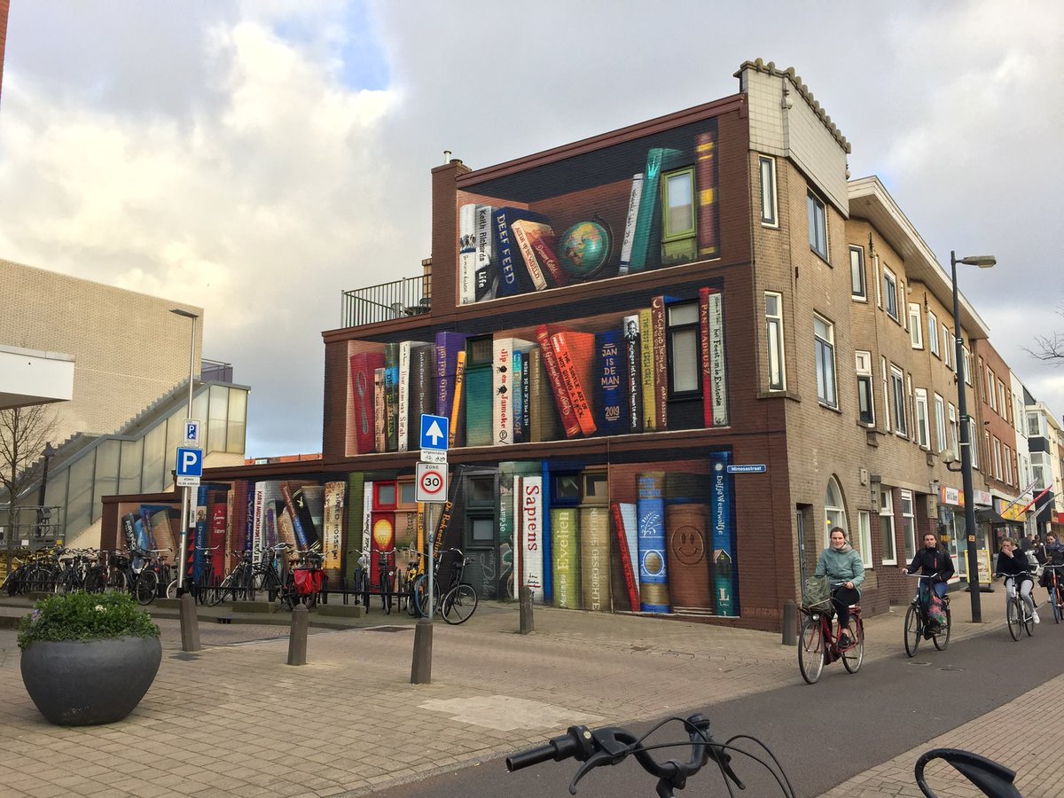 iPoetryinfo's tweet photo. A new mural in Utrecht, Netherlands by #JanIsDeMan (front) & #DeefFeed. The artists asked residents for their favorite books and then included those into the mural. https://t.co/p4IfM8iDhX