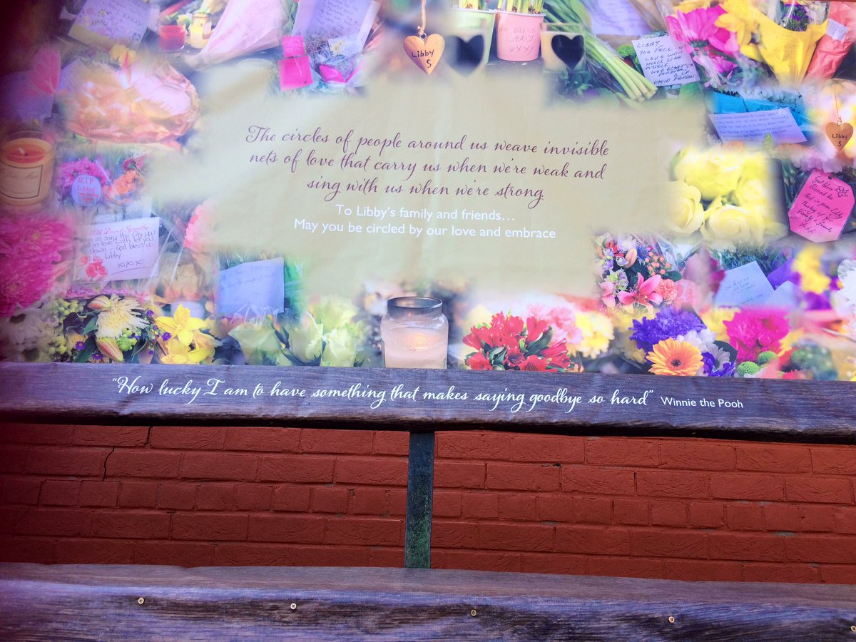 jo_makel's tweet image. Some flowers are being left, given fresh water and food. A huge banner showing a montage of the flowers has been put up and the bench decorated with a quote from Winnie The Pooh. #LibbySquire