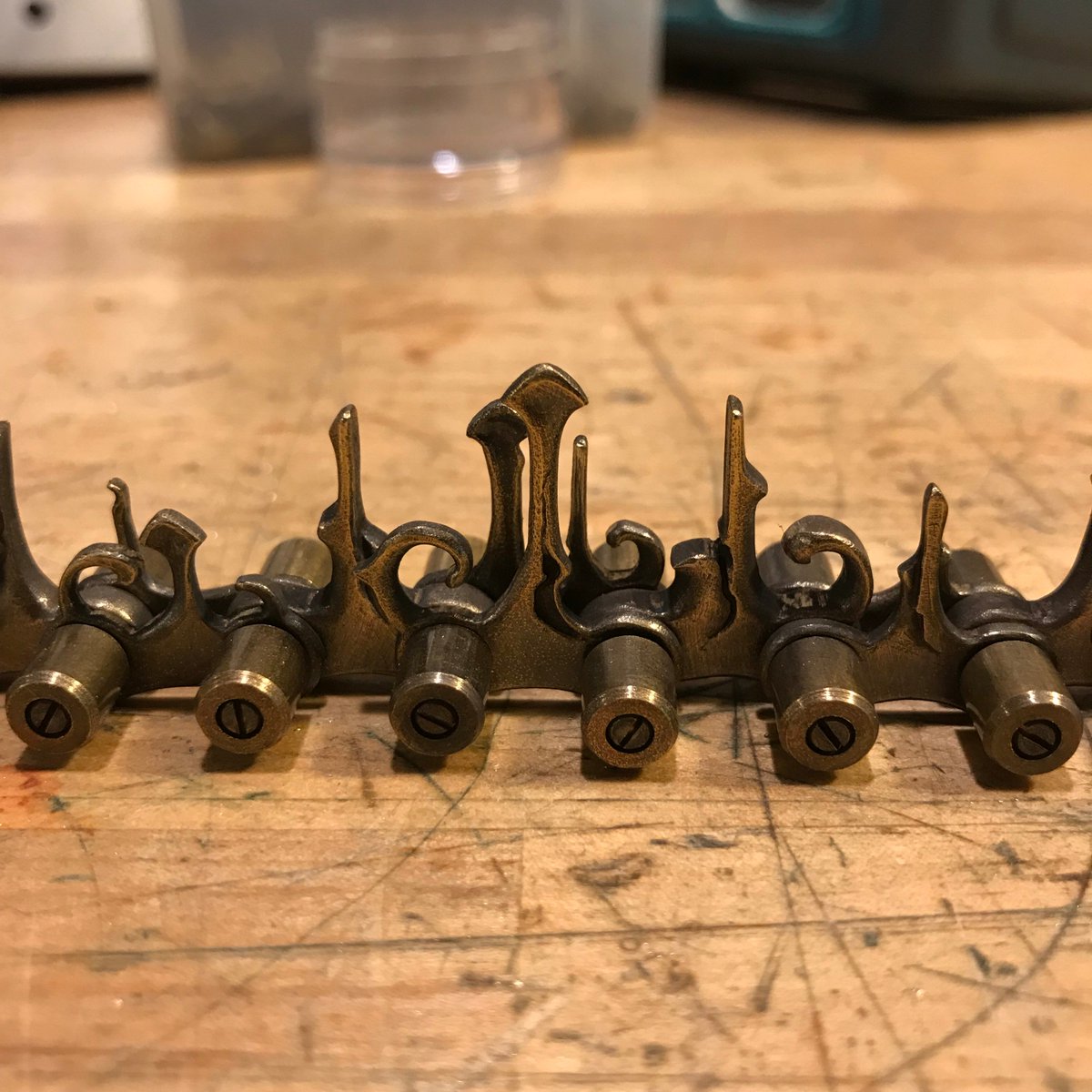EricFreitas12's tweet photo. My latest commission will feature a nine-foot handmade chain. Here are a few closeup shots of the more detailed segments. Three feet finished, six to go. https://t.co/we7xry16EV
