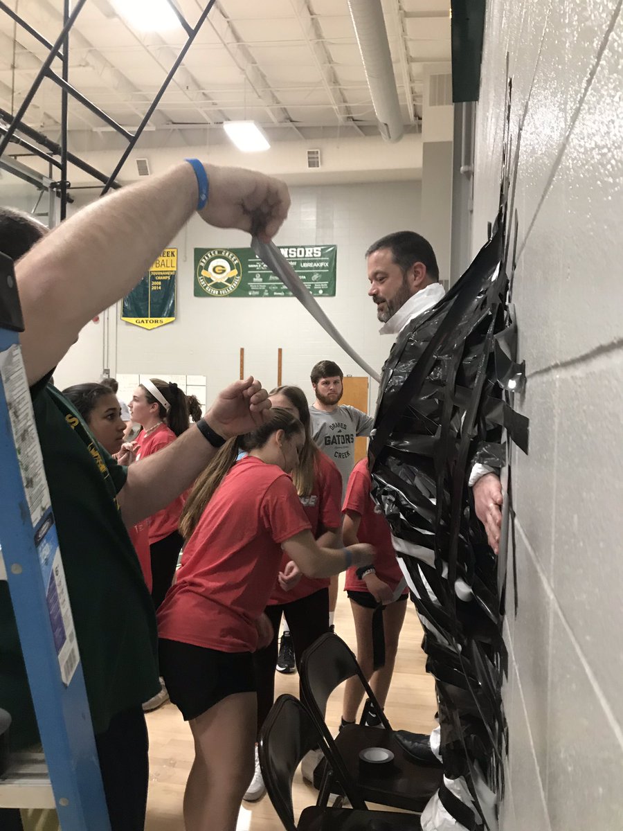 DCMSperks's tweet photo. When you raise enough money to tape your principal to the wall @DrakesCreekMS #hoopsforheart https://t.co/lFbtKrS3V2